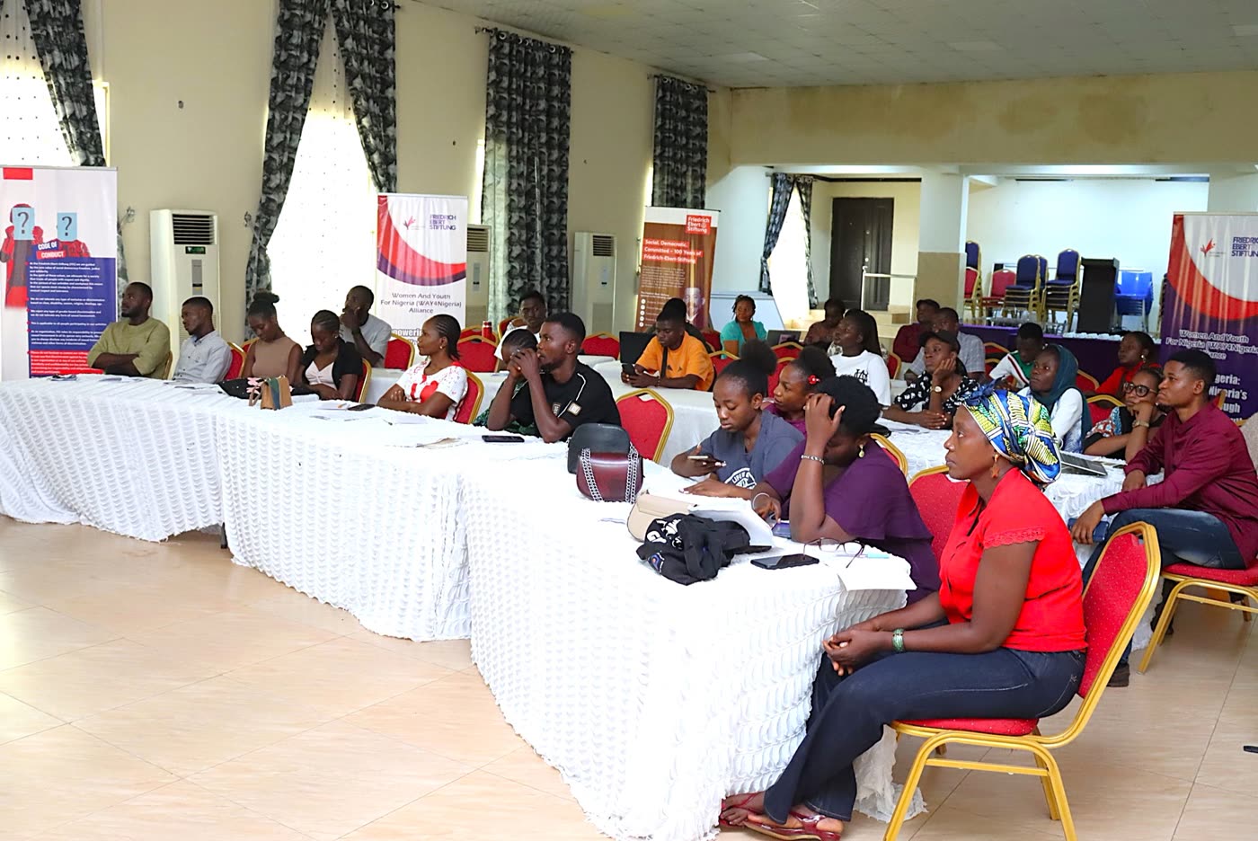Participants seated at training tables during a WAY4Nigeria session